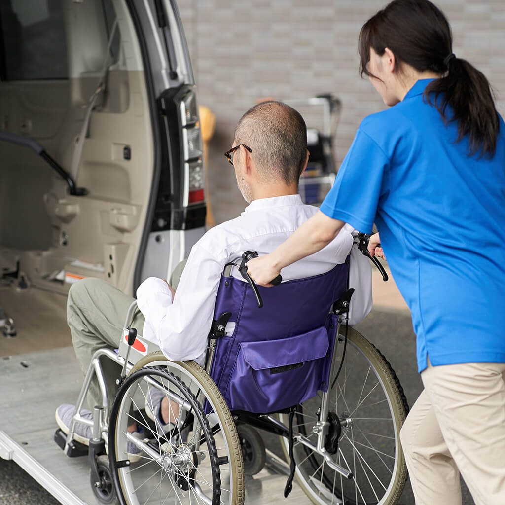woman assists man in wheelchair into van 2026 03 24 00 36 26 utc